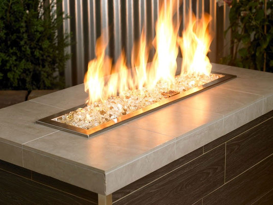 merican Fire Products 1/2 inch Gold reflective fire glass installed in outdoor fire pit creating golden flame reflections