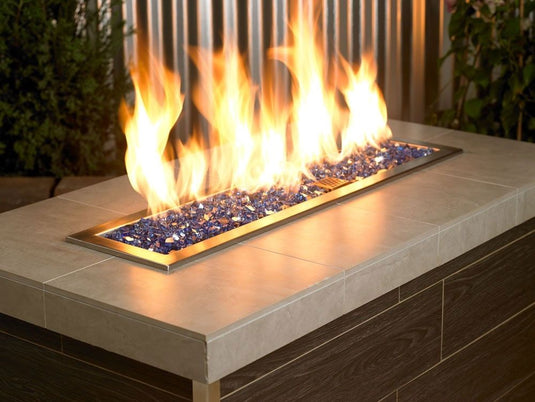 American Fire Products 1/4 inch Cobalt reflective fire glass used in outdoor fire pit creating dramatic blue flame reflection
