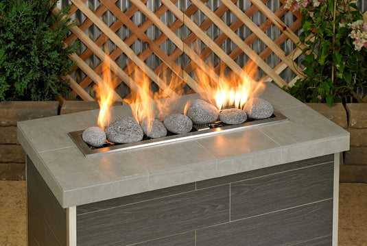 American Fire Products extra large gray tumbled lava stones 4 to 6 inch fire pit media use case showing volcanic rock as top layer decorative fire feature in gas fire pit with flames