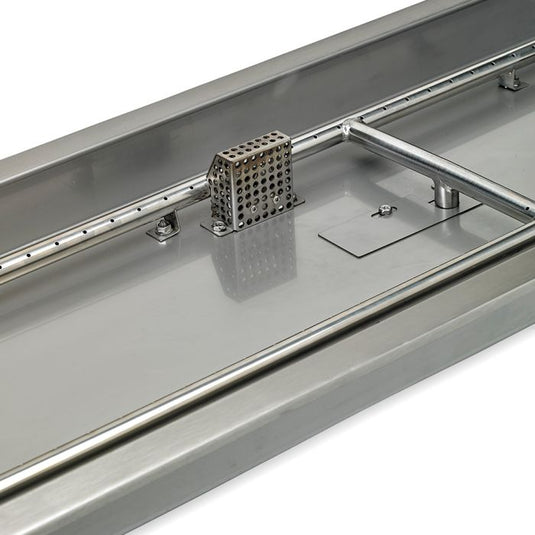 Close-up detail of stainless steel construction of linear burner pan showing brushed metal surface and burner slot design for fire pit use