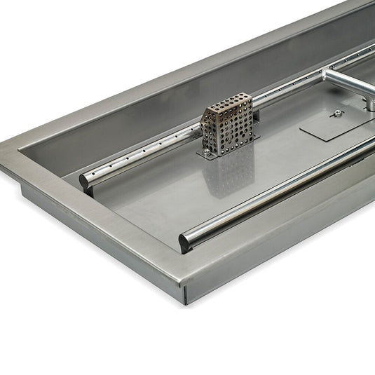 Close-up detail of stainless steel construction of linear burner pan showing brushed metal surface and burner slot design for fire pit use