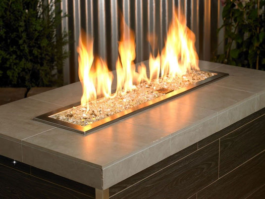 American Fire Products 1/4 inch Gold reflective fire glass used in outdoor fire pit creating warm golden flame reflection effect