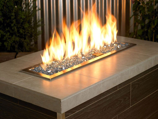 American Fire Products 1/4 inch Pacific Blue reflective fire glass used in outdoor fire pit creating blue flame reflection effect