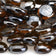 Load image into Gallery viewer, Close-up of American Fire Products Root Beer Luster Fire Beads showing the brown luster finish and tempered fire glass
