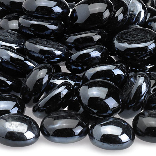 Close up view of Twilight Luster fire beads showing smooth black glass texture with reflective shine