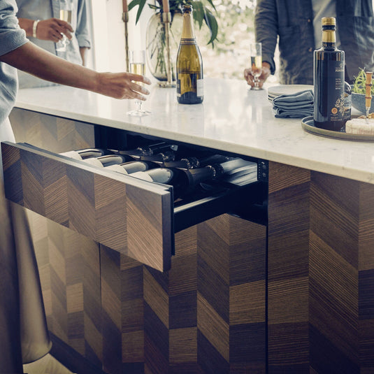 Dometic DrawBar 5C compact wine cooler with clear glass drawer front, built-in under cabinet design storing five wine bottles with LED lighting