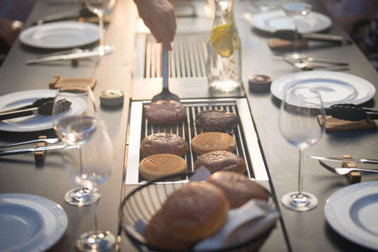 Festavolo Stainless Steel Grill Grate cooking burgers on a grill table