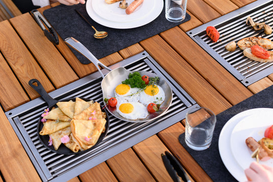 Festavolo Stainless Steel Grill Grate with eggs cooking in a pan