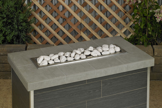 Cottage white linear lite stones arranged in a modern fireplace creating a warm and cozy fire feature with elegant flame contrast
