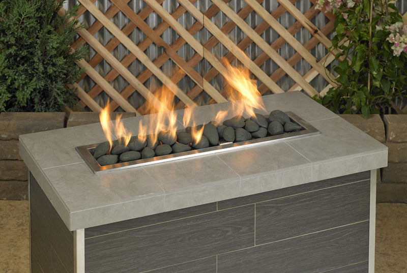 Load image into Gallery viewer, Matte black linear lite stones in a fireplace with visible flames creating a modern and elegant fire feature display
