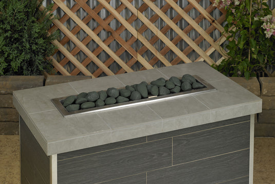 Matte black linear lite stones arranged in a modern fireplace fire feature design with a clean minimalist aesthetic