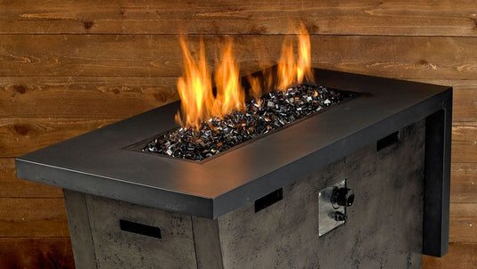 Luxury outdoor fire pit featuring Bronze Luster 2.0 Fire Glass Cubes with bright flames reflecting through bronze glass cubes