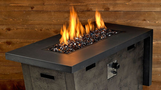 Luxury outdoor fire pit featuring Copper Luster 2.0 Fire Glass Cubes with warm flame reflections across copper glass cubes