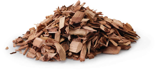 Close-up of Napoleon 67007 natural apple hardwood smoking chips in a pile on a white background