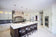 Load image into Gallery viewer, Napoleon Allure Vertical 38-inch wall-mounted electric fireplace installed in a modern white kitchen
