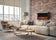 Load image into Gallery viewer, Napoleon Astound FlexMount 50-inch electric fireplace NEFL50AB wall-mounted on a brick accent wall above a beige sectional sofa.
