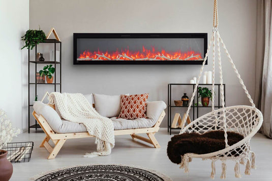 Napoleon Entice linear electric fireplace wall-mounted above a sofa in a bright living room with a hanging chair