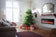 Load image into Gallery viewer, Napoleon Entice 50-inch electric fireplace installed in a festive living room with a decorated Christmas tree
