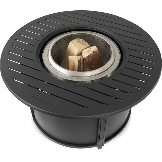Top angled view of Napoleon NWO44TI-BK round fire pit table surround with stainless steel fire pit and firewood inside