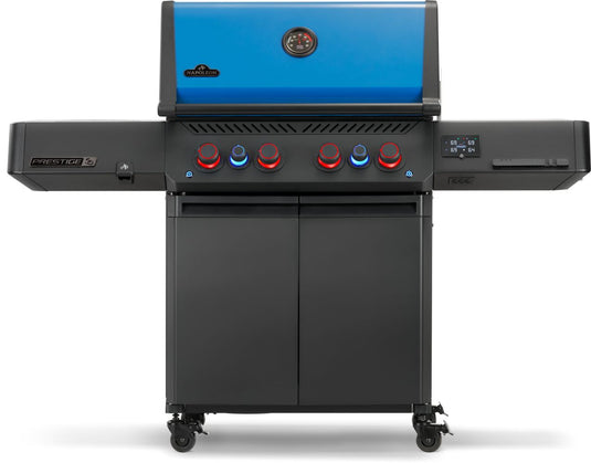 Front view of Napoleon Prestige 500 50th Anniversary propane grill with red and blue illuminated control knobs