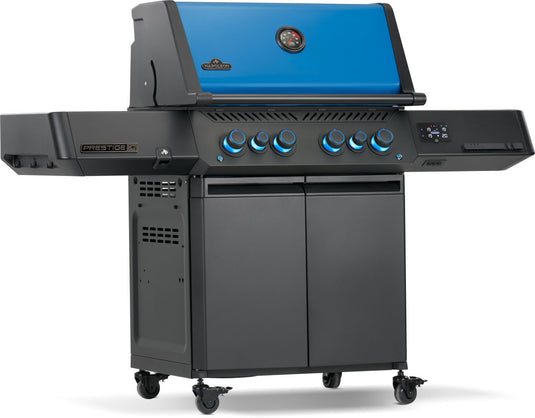 Napoleon Prestige 500 50th Anniversary propane grill viewed from the right with blue illuminated knobs