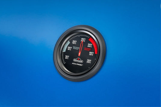 Angled close-up of the Napoleon ACCU-PROBE temperature gauge on the Heritage Blue lid