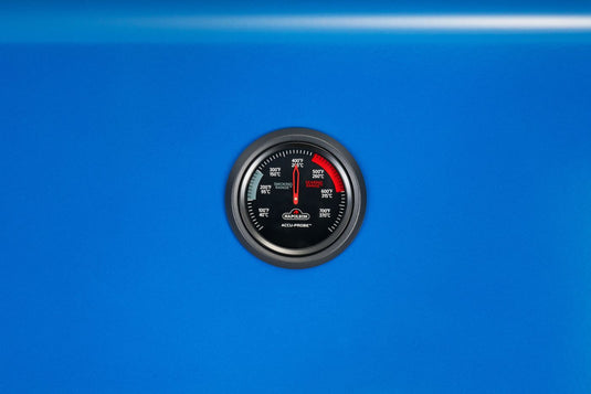 Front close-up of the Napoleon ACCU-PROBE temperature gauge centered on the Heritage Blue lid