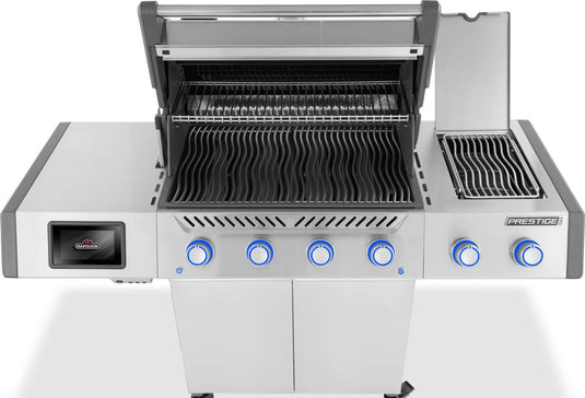 Top view of Napoleon Prestige PRO 500 with main and side burner lids open, showing WAVE grids and warming rack