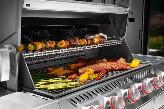 Napoleon Prestige PRO 665 Elite stainless steel cooking grids and warming rack with grilled meats and vegetables