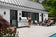 Load image into Gallery viewer, Napoleon Prestige PRO 665 Elite gas grill in a modern outdoor patio entertainment area
