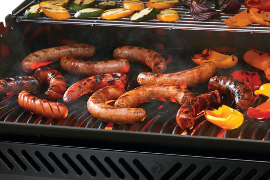 Grilled sausages and vegetables on a barbecue grill