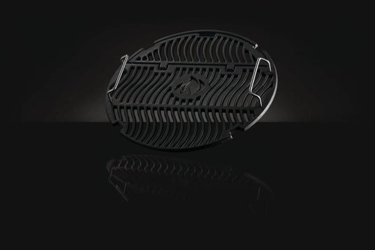 Napoleon S83047 18-inch cast iron cooking grids displayed at an angle against a black background