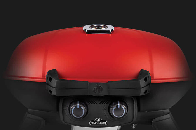 Load image into Gallery viewer, Napoleon TravelQ 285X red portable propane gas grill with scissor cart and reversible cast iron griddle, featuring 2 burners for versatile outdoor cooking
