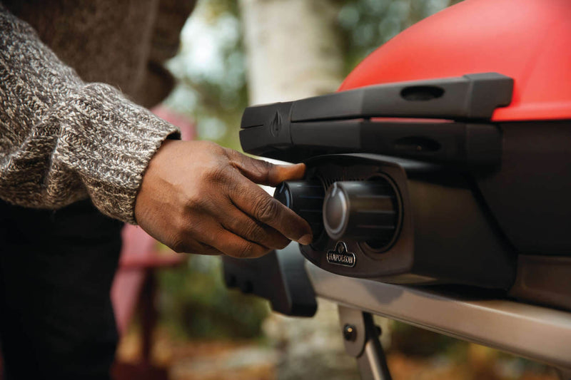 Load image into Gallery viewer, Napoleon TravelQ 285X red portable propane gas grill with scissor cart and reversible cast iron griddle, featuring 2 burners for versatile outdoor cooking
