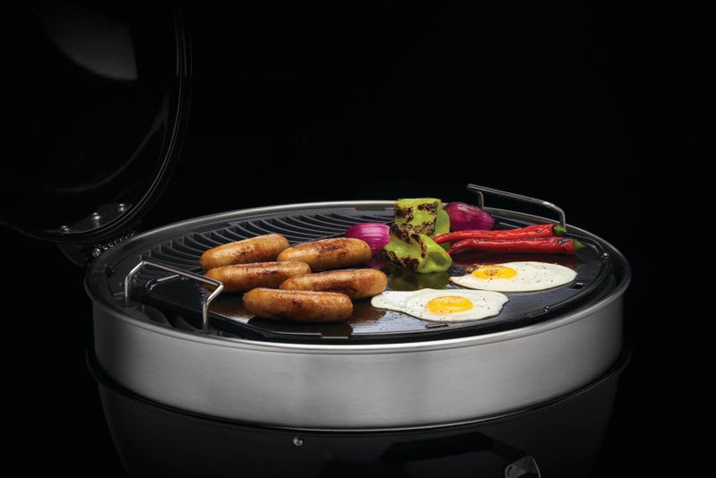 Load image into Gallery viewer, Napoleon cast iron reversible griddle for 22-inch charcoal kettle grill, showing flat and raised grilling surfaces

