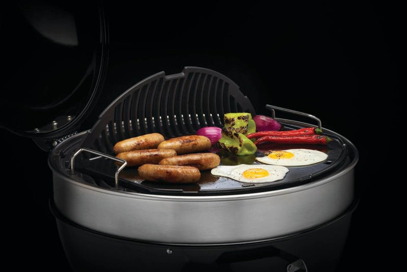 Load image into Gallery viewer, Napoleon cast iron reversible griddle for 22-inch charcoal kettle grill, showing flat and raised grilling surfaces
