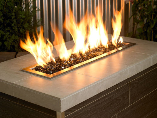 Outdoor fire pit filled with 1/2 inch Black Fire Glass producing bold flames and modern decorative appeal