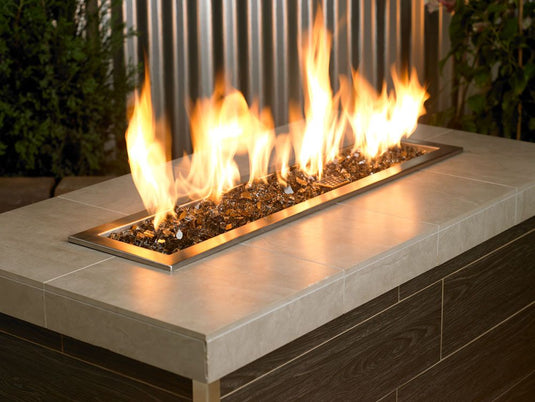 Outdoor fire pit filled with 1/2 inch Bronze Fire Glass producing warm flames and elegant decorative appeal