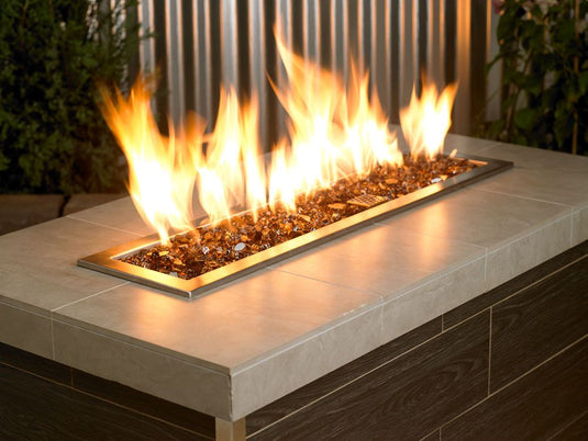 Outdoor fire pit filled with 1/2 inch Copper Fire Glass producing warm flames and elegant decorative appeal