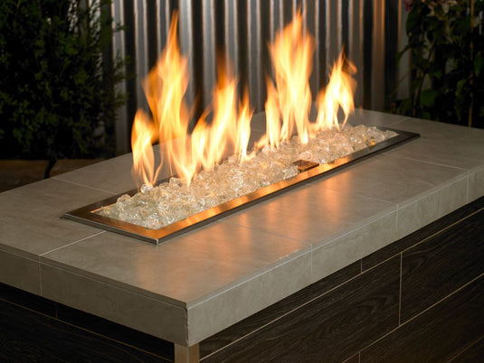 Outdoor fire pit filled with Ice Medium fire pit glass creating the appearance of flames dancing over crystal-clear glass