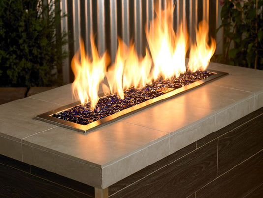 Outdoor fireplace featuring Royal Blue Luster fire beads enhancing flame color and creating a premium decorative fire display