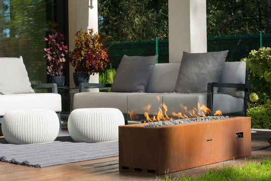 Planika Galio Corten freestanding outdoor gas fireplace installed on a modern patio