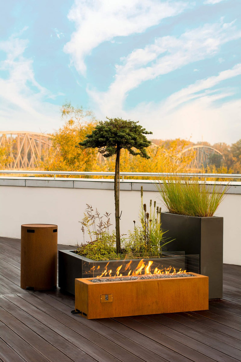 Load image into Gallery viewer, Planika Galio Corten freestanding outdoor gas fireplace installed on a modern patio
