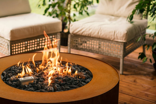 Planika Galio Star Corten outdoor gas fireplace installed on luxury patio with multidimensional flames