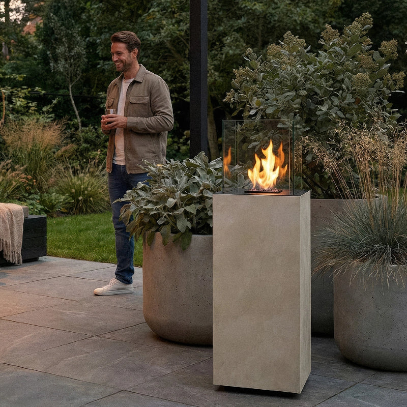 Load image into Gallery viewer, Planika Porto Nacre freestanding fireplace used in a modern outdoor lounge area
